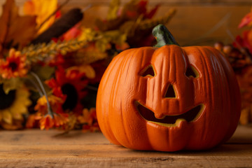 Fototapeta premium Halloween pumpkin head jack lantern on a wooden background, background for the holiday