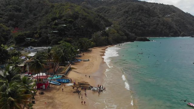 Stunning aerial view of a shoreline with fishermen attending to the dragnet catch