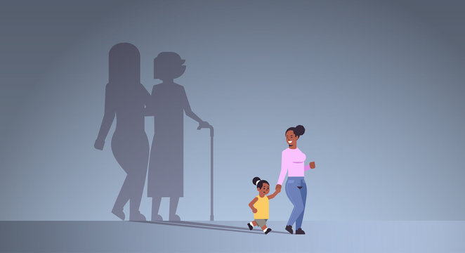 African American Mother With Daughter Holding Hands Shadow Of Young And Mature Woman Standing Together Imagination Aspiration Concept Full Length Flat Horizontal