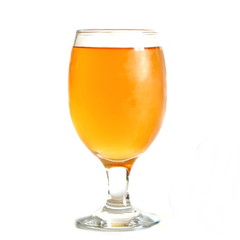 Misted glass goblet with light juice on white background. Isolated