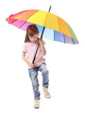 Cute little girl with umbrella on white background