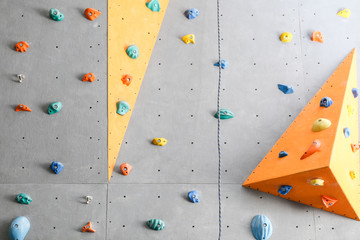 Wall with climbing holds in gym