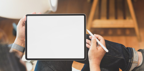 Young male freelancer holding blank screen tablet - Powered by Adobe