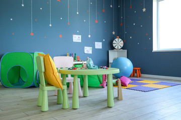 Stylish interior of modern playroom in kindergarten