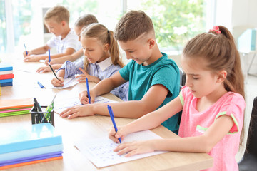 Pupils passing school test in classroom