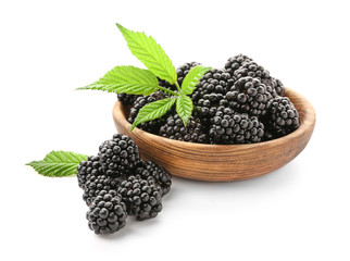Bowl with ripe blackberry on white background