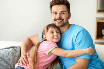 Portrait of happy father with daughter at home