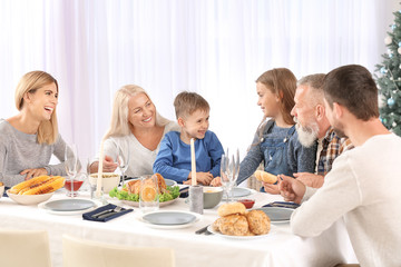 Happy family having Christmas dinner at home