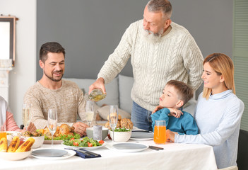 Happy family having Christmas dinner at home