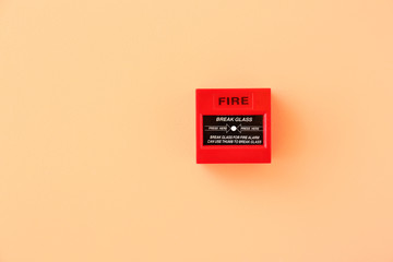 Modern manual call point of fire alarm system on color wall