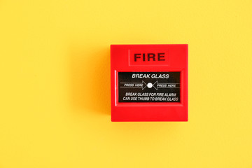 Modern manual call point of fire alarm system on color wall - obrazy, fototapety, plakaty