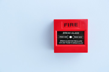 Modern manual call point of fire alarm system on color wall