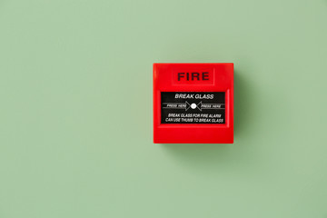 Modern manual call point of fire alarm system on color wall