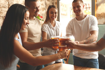 Friends drinking fresh beer in pub