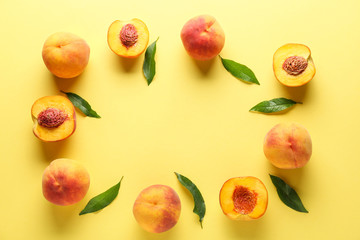 Frame made of ripe peaches on color background