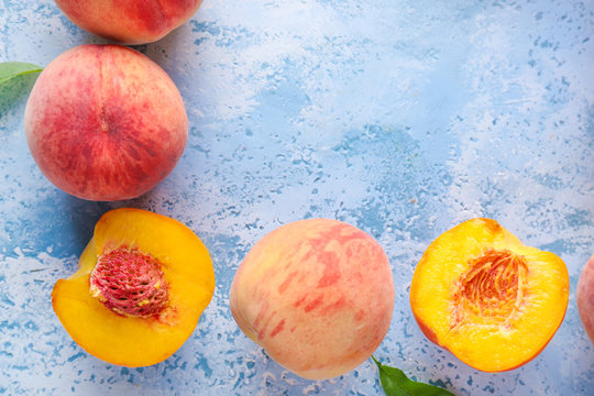 Ripe peaches on color background