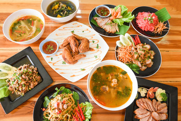 Table food served on plate / Tradition northeast food Isaan delicious on plate with fresh vegetables - Many variety various Thai menu Asian food on a wooden table