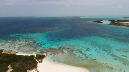 Fototapeta na wymiar Caribbean: Vacation in the blue sea and deserted islands. Aerial view of a blue sea with crystal water. Great landscape. Beach scene. Aerial View Island Landscape Los Roques