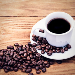 A cup of coffee and scattered coffee beans. Layout. Flat lay. Coffee bean.