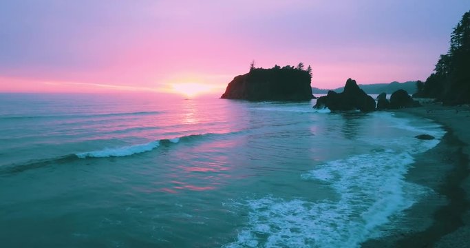 The large island at Ruby Beach being filmed with a drone during sunset.