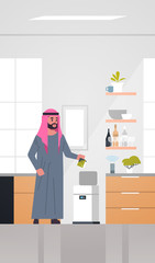 arab man putting trash in electronic recycling bin controlled by smart speaker voice recognition activated digital assistant concept modern kitchen interior vertical full length