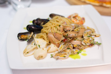 seafood spaghetti - Italian stir fried noodle with squid , clam , mussel and prawn with olive oil and herb