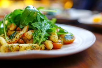 Pan fried calamari garlic topped with rocket leaves