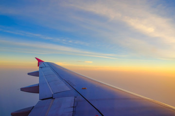 Plakat Flying and traveling, view from airplane window on the wing on sunset time