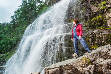 Tourist woman at waterfall Svandalsfossen, Norway