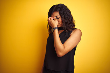 Transsexual transgender elegant businesswoman standing over isolated yellow background tired rubbing nose and eyes feeling fatigue and headache. Stress and frustration concept.