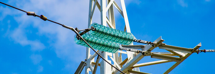 Line insulator on the electrical wires of a high-voltage tower. Electric wires. High-voltage power...