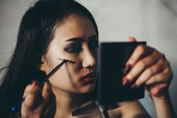 Young woman makeup on halloween night. Face art design, Celebration on the Halloween festivities.