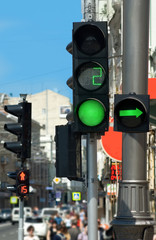 Images of green traffic lights and people..People are moving across the street and red traffic...