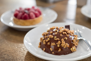 Raspberries Tart and Chocolate dome cake on plate
