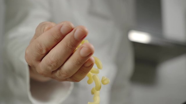 SLOW MOTION: Chef Pours Macaroni While Cooking