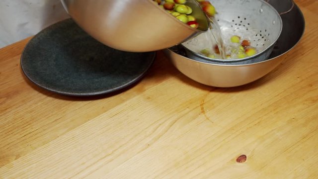 A Japanese female chef rinsing Japanese Ume at home kitchen, Tokyo, Japan. May 2019. Camera fixed, Close-up, high angle