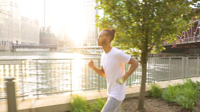Attractive African American man having he morning jog along the Chicago River in Chicago.
