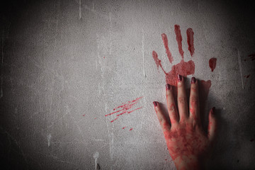 Nightmares of scary fear at the halloween festival. Bloody hands placed on a solid wall, Horror and...