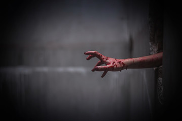 Nightmares of scary fear at the halloween festival. Close up bloody hands protruding from the wall, Horror and terror. © Sumala