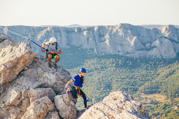 Man and Woman climbing mountain. 