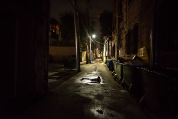 Dark and eerie urban city alley at night 