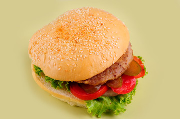 fresh tasty burger isolated on yellow background.