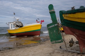 Fishing boats on the beach of Baltic Sea in Sopot/Poland - close-up of the boat propeller and rudder blade.