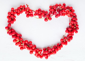 Obraz premium Schisandra chinensis or five-flavor berry. Fresh red ripe berries on white background. Top view. Copy space. Food background.