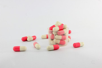 Pink and white capsules on white background. Antimicrobial capsule pills, Pharmacy. 