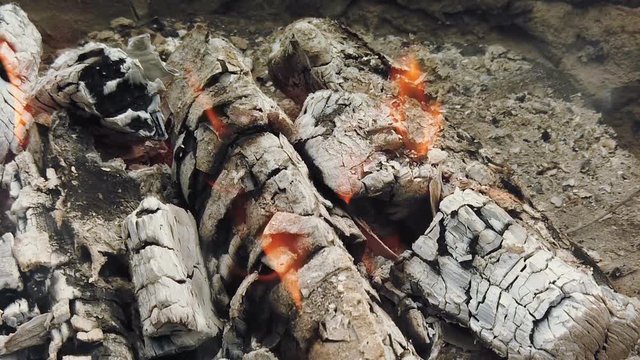 Close view at glowing charcoal and flame in barbecue grill