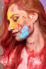 fashion stylish colorful female face. profile of beautiful woman with painting smears, abstract makeup. Multicolor creative make-up.