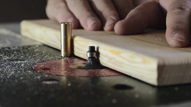 Removing an edge from a tree using a milling machine. Close-up. Slow motion.