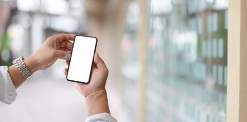Young man touching blank screen smartphone with blurred background