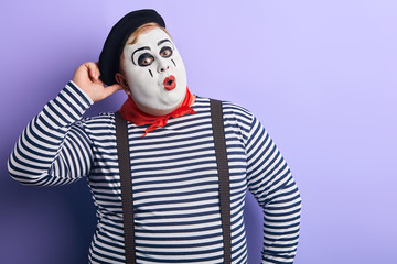 funny plump mime scratching his head and looking at the camera, being surprised at sale, discounts. copy space.place for advert, text